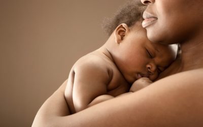 A baby resting on their mother's chest