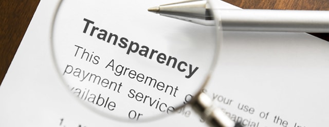 Why more people would give office romance a shot in 2023 2 Magnifying glass over agreement paperwork and pen