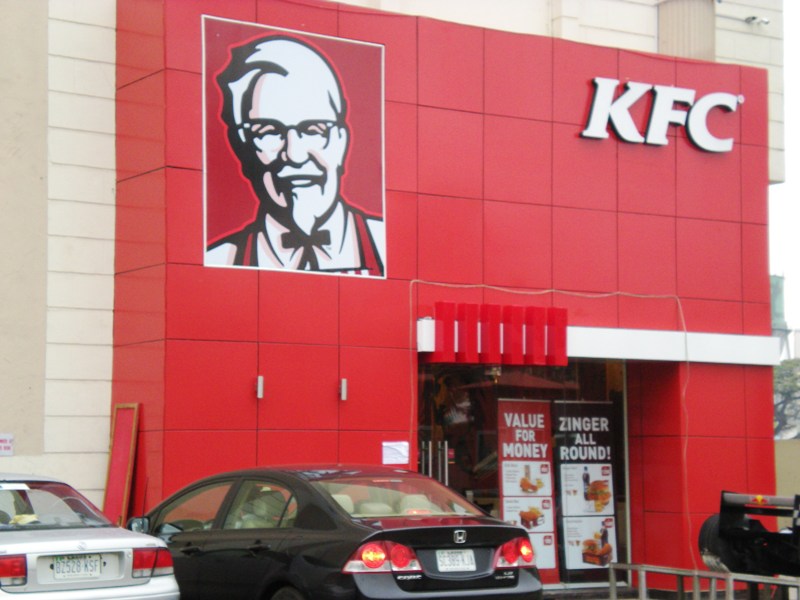Nigerian forex crisis and the collateral damage to local businesses 6 KFC building in Lagos with two cars parked in front