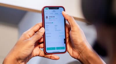 An image of an iPhone with the Bamboo investment app. The user is attempting to invest in Amazon