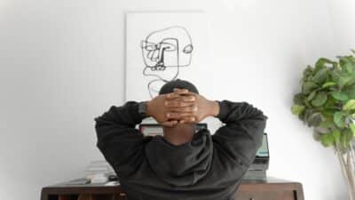 man in a grey hoodie sitting on a chair, freelancer