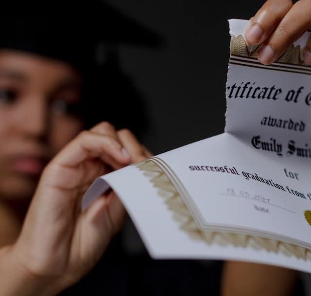 Tech recruiter shares how to land the best African talents 2 A black female student tearing up certificate of graduation