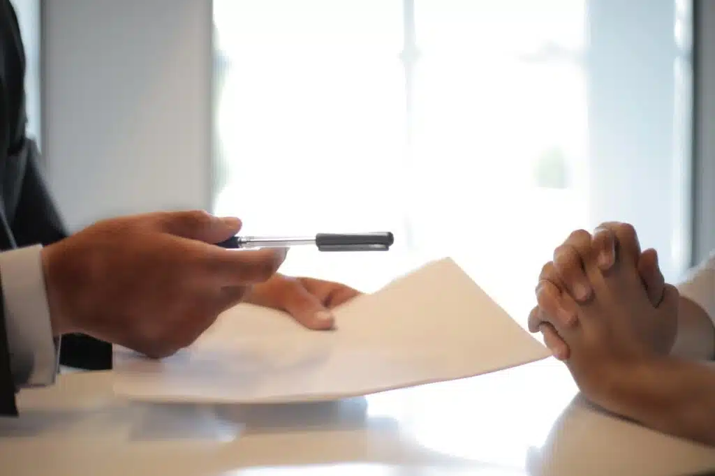 Businessman giving contract to woman to sign