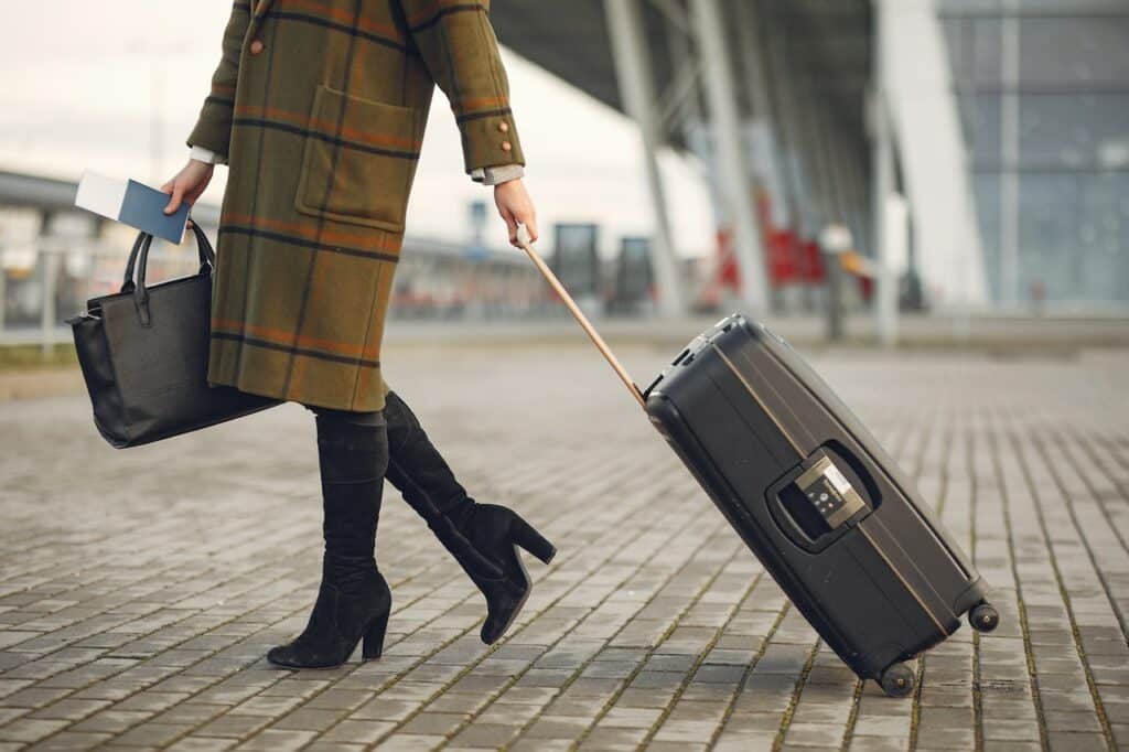 The year of quiets: 8 popular workplace terms trending since 2022 3 stylish woman with suitcase and bag walking on street near modern airport terminal