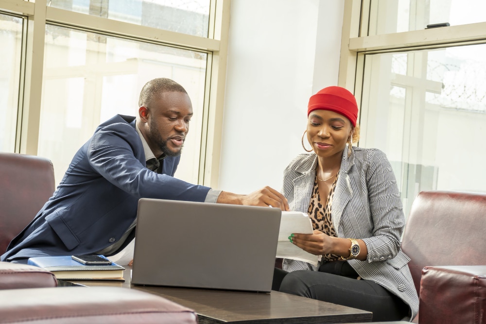 Telecom Egypt and Huawei to launch first public cloud in Northern Africa 2 young black businessman woman going through some paperwork together