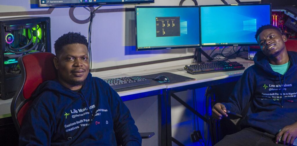 Building custom PCs might not be common in Nigeria, but here's how Fope Davies made ₦252m from it in 2022 4 Debusayo Ayibiowu and Enitan Giwa sitting next to computer setups