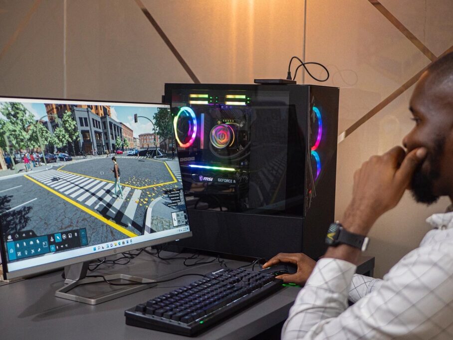 Building custom PCs might not be common in Nigeria, but here's how Fope Davies made ₦252m from it in 2022 3 Someone using a monitor and PC setup with RGB lighting.