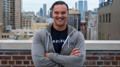 Paxful CEO, Ray Youssef standing atop a building posing for a photo.