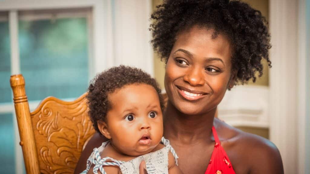 Zimbabwe to launch gold-backed digital currency 1 Smiling mother carrying a baby