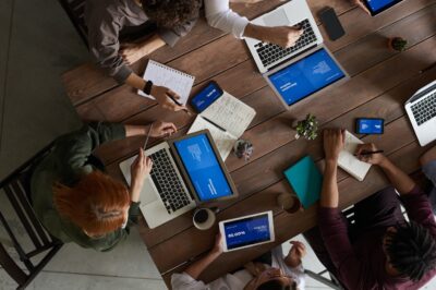 Photo Of People Sitting Near Wooden Table