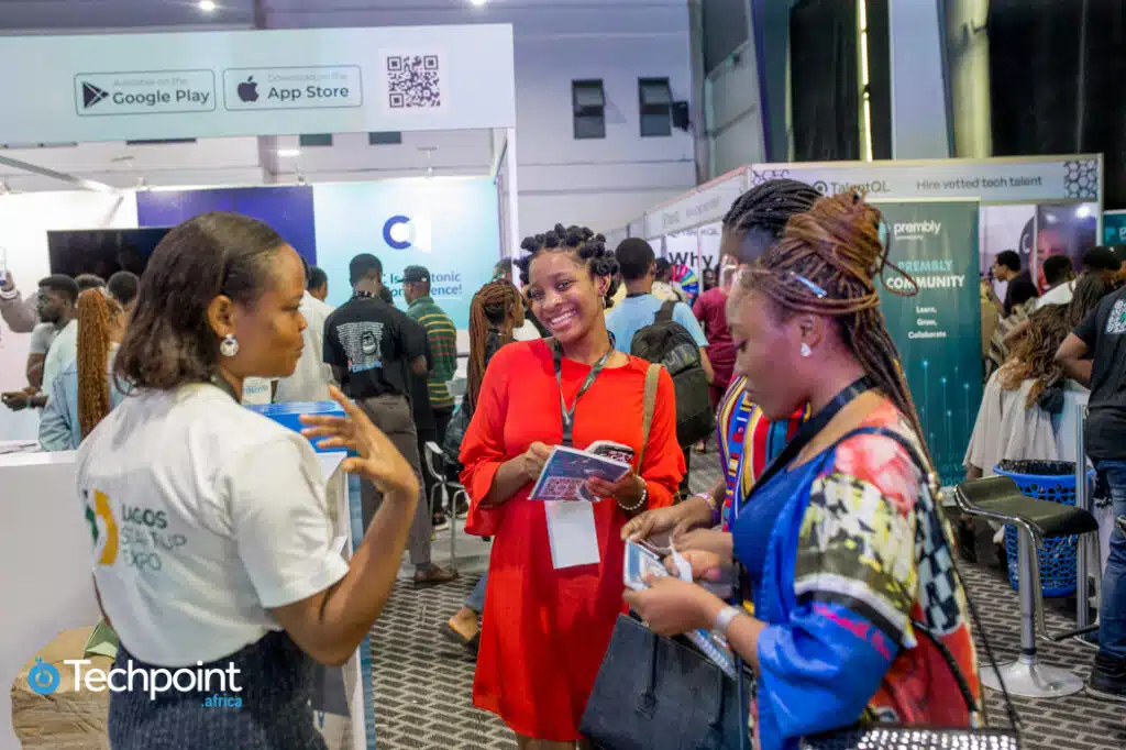 An exhibitor speaking to attendees at the Lagos Startup Expo