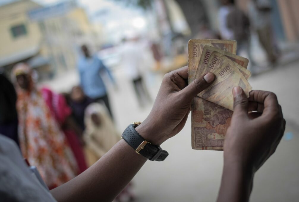 Ghana's Boost partners Mastercard to provide digital payment wallets 4 image showing someone counting money