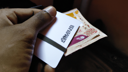 What Sweden and India can teach Nigeria about the cashless economy 2 A picture of someone making payment-with-a-card-and-Rupees