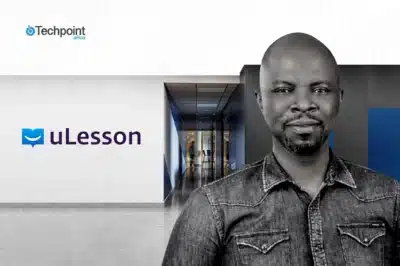 An image of Sim Shagaya placed in front of a hallway leading into a building with uLesson inscription on the wall