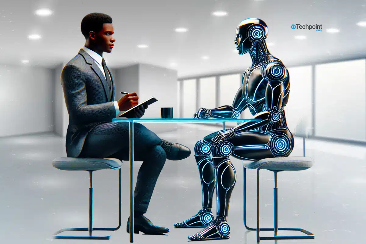 An image showing a human recruiter interviewing a robot applicant