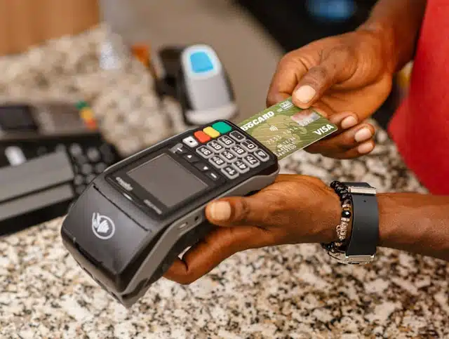 Someone using an ATM card at a Point of sale machine